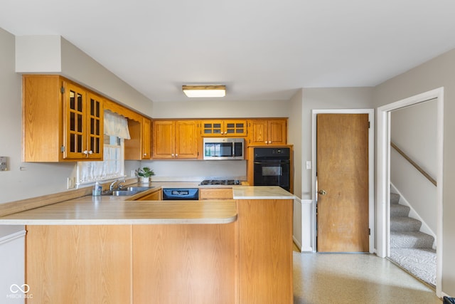 3388 S Leonard Rd, New Palestine, IN 46163 - kitchen with black appliances, light countertops, a peninsula, glass insert cabinets, and brown cabinetry