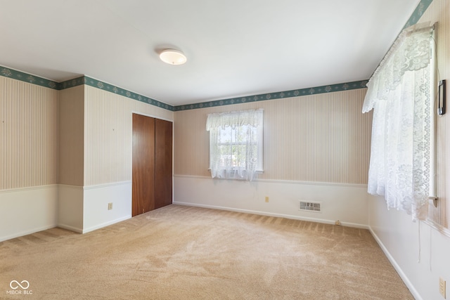 3388 S Leonard Rd, New Palestine, IN 46163 - unfurnished bedroom featuring a closet, carpet floors, and wallpapered walls