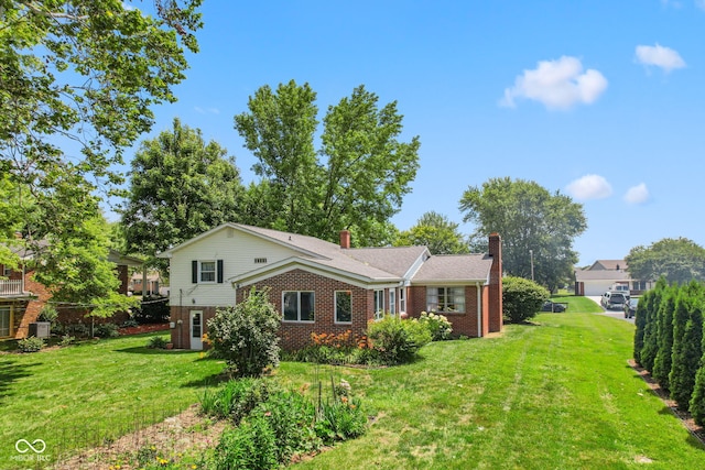 3388 S Leonard Rd, New Palestine, IN 46163 - view of front of property featuring brick siding, a chimney, and a front lawn