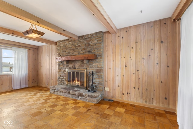 3388 S Leonard Rd, New Palestine, IN 46163 - unfurnished living room featuring wood walls, beamed ceiling, and a fireplace