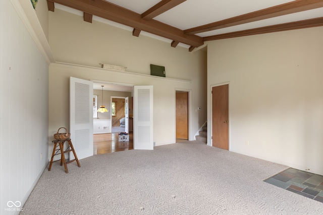 3388 S Leonard Rd, New Palestine, IN 46163 - unfurnished bedroom featuring carpet flooring, beam ceiling, high vaulted ceiling, and a heating unit