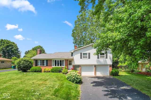 3388 S Leonard Rd, New Palestine, IN 46163 - tri-level home with brick siding, a garage, driveway, and a front yard