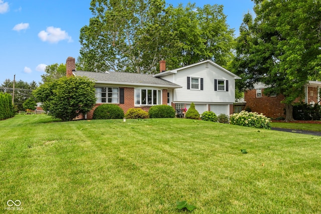 3388 S Leonard Rd, New Palestine, IN 46163 - tri-level home featuring a chimney, a front lawn, and an attached garage
