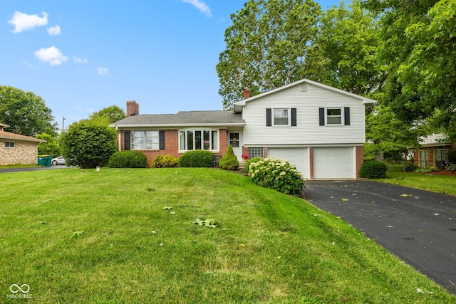 3388 S Leonard Rd, New Palestine, IN 46163 - split level home featuring brick siding, a garage, driveway, a chimney, and a front lawn