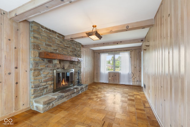 3388 S Leonard Rd, New Palestine, IN 46163 - unfurnished living room with a fireplace, beam ceiling, and wooden walls