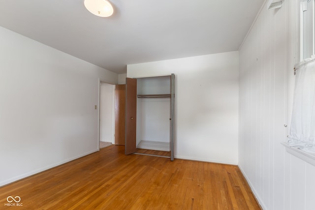 3388 S Leonard Rd, New Palestine, IN 46163 - unfurnished bedroom with light wood finished floors and a closet