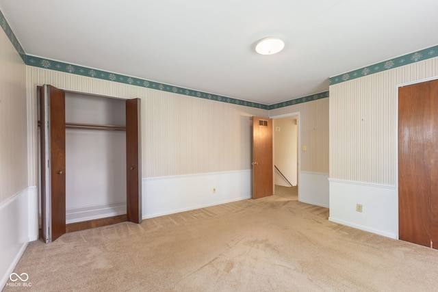 3388 S Leonard Rd, New Palestine, IN 46163 - unfurnished bedroom featuring wallpapered walls, carpet flooring, a closet, and wainscoting