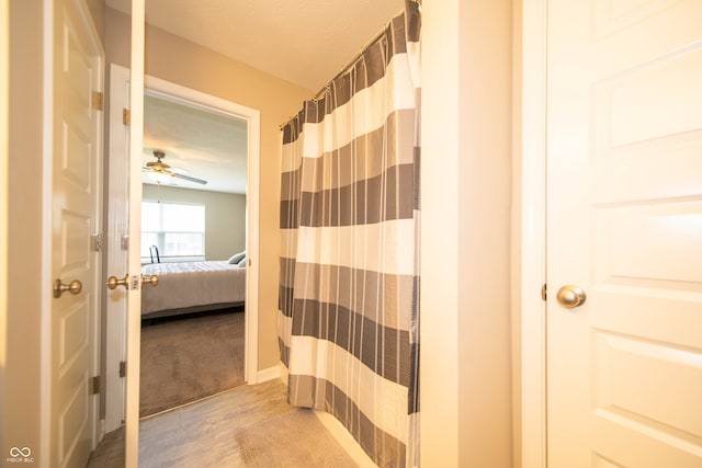 610 Sawtooth St, Westfield, IN 46074 - full bathroom with ensuite bathroom, wood finished floors, a shower with shower curtain, ceiling fan, and a textured ceiling