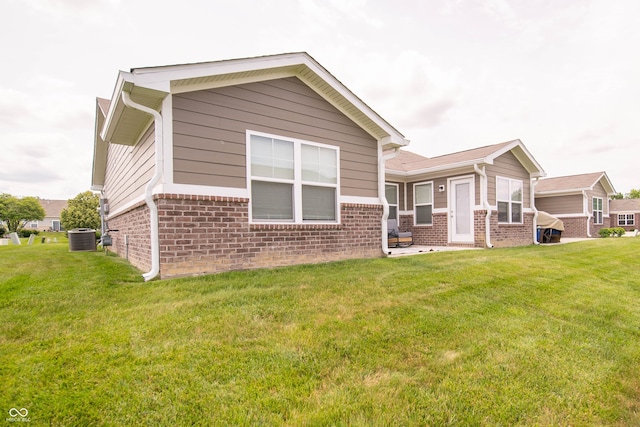 610 Sawtooth St, Westfield, IN 46074 - rear view of property with brick siding and a lawn