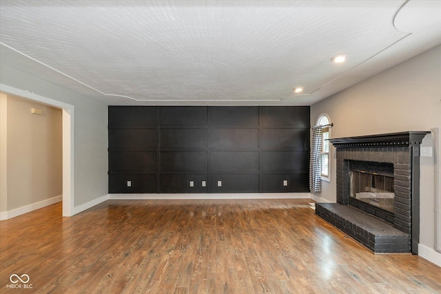 12661 Doe Ln, Indianapolis, IN 46236 - unfurnished living room featuring wood finished floors, a fireplace, and recessed lighting