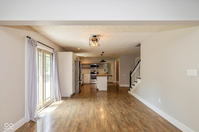 12661 Doe Ln, Indianapolis, IN 46236 - unfurnished living room with dark wood-type flooring, stairway, and a textured ceiling