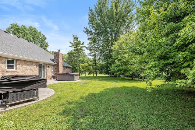 12661 Doe Ln, Indianapolis, IN 46236 - view of green lawn featuring a hot tub and a patio