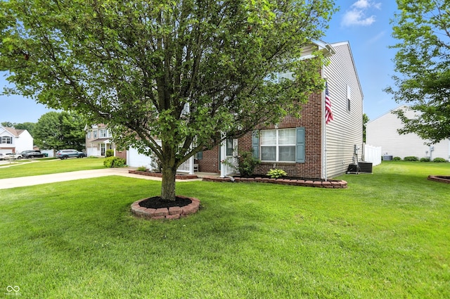 5063 Haywood Ln, Plainfield, IN 46168 - view of property hidden behind natural elements featuring brick siding, a front lawn, concrete driveway, and a garage