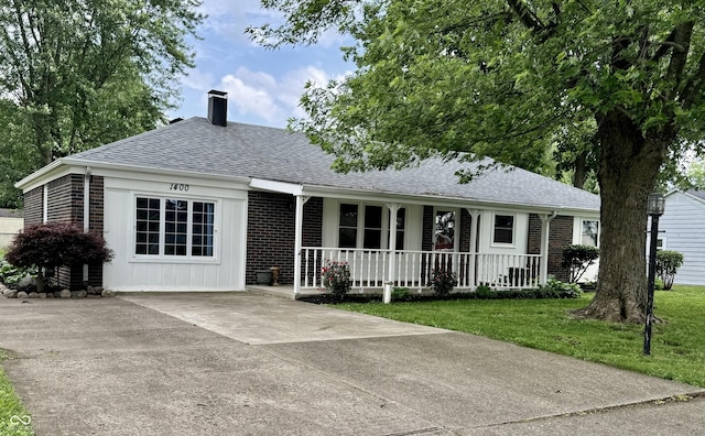 1400 Evelyn Ln, Anderson, IN 46017 - view of front of home with covered porch, a shingled roof, a chimney, brick siding, and concrete driveway