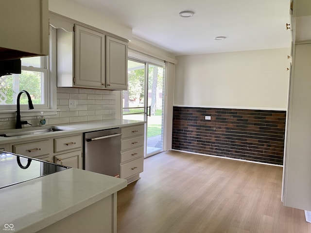 1400 Evelyn Ln, Anderson, IN 46017 - kitchen featuring dishwasher, light wood-type flooring, and backsplash