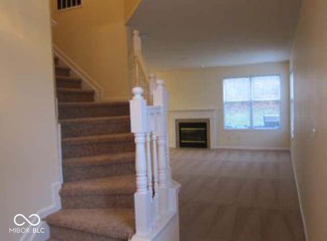 8333 Pine Branch Ln, Indianapolis, IN 46234 - stairway with carpet floors and a fireplace