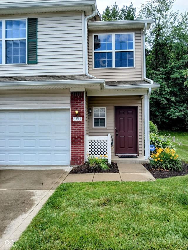 8333 Pine Branch Ln, Indianapolis, IN 46234 - view of front of property featuring brick siding, a garage, and a front yard