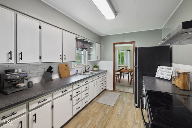 11710 W State Road 32, Yorktown, IN 47396 - kitchen featuring light wood-style flooring, white cabinetry, tasteful backsplash, dark countertops, and extractor fan