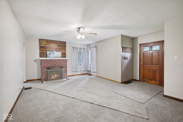 11710 W State Road 32, Yorktown, IN 47396 - unfurnished living room featuring a fireplace, a ceiling fan, carpet flooring, and a textured ceiling