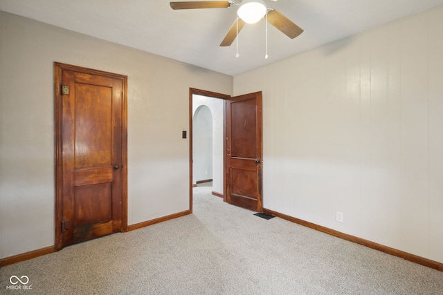 11710 W State Road 32, Yorktown, IN 47396 - unfurnished bedroom with carpet flooring, arched walkways, and a ceiling fan