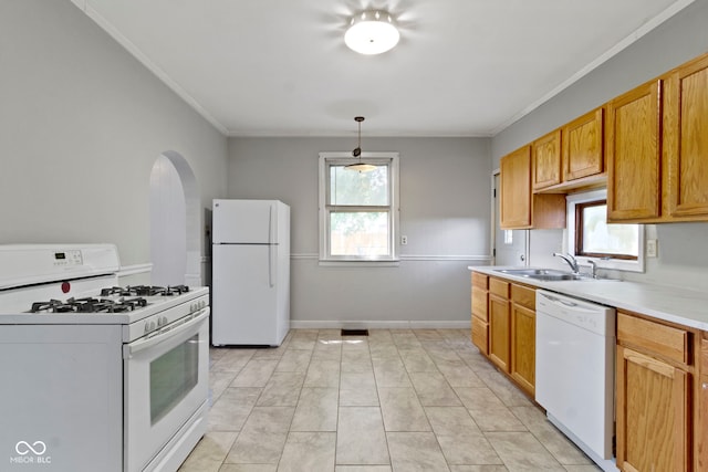 29 E Caven St, Indianapolis, IN 46225 - kitchen featuring white appliances, crown molding, light countertops, healthy amount of natural light, and arched walkways
