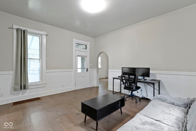 29 E Caven St, Indianapolis, IN 46225 - living area featuring arched walkways, crown molding, wood finished floors, and a wainscoted wall