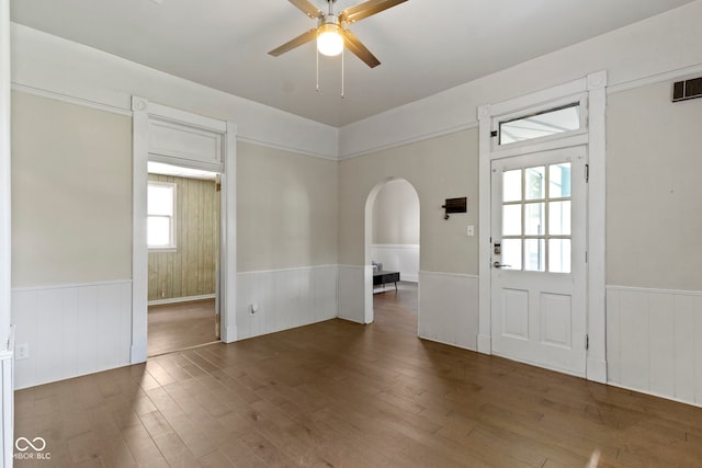 29 E Caven St, Indianapolis, IN 46225 - entryway featuring a wainscoted wall, arched walkways, a ceiling fan, wood finished floors, and plenty of natural light