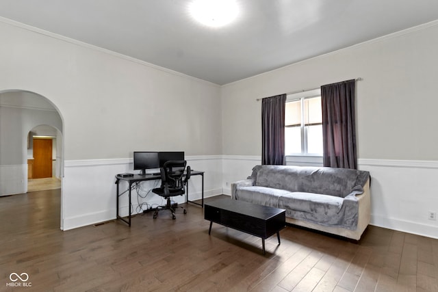 29 E Caven St, Indianapolis, IN 46225 - living area with arched walkways, wood finished floors, wainscoting, crown molding, and a desk