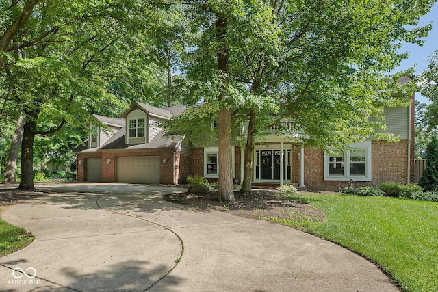 3710 Canada Ct, West Lafayette, IN 47906 - obstructed view of property with brick siding, driveway, a garage, and a front yard