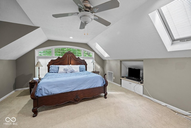 3710 Canada Ct, West Lafayette, IN 47906 - bedroom with a skylight, vaulted ceiling, light carpet, and ceiling fan