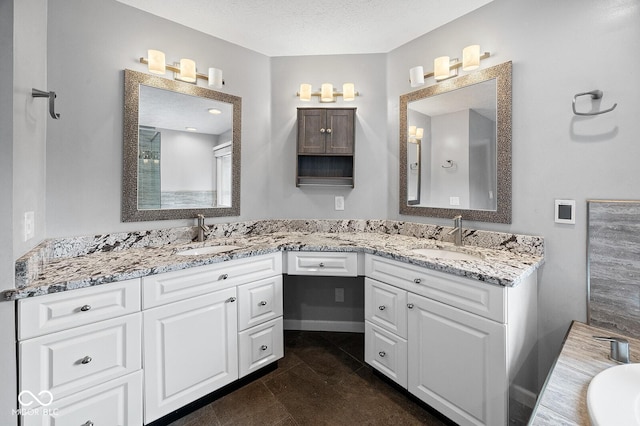 3710 Canada Ct, West Lafayette, IN 47906 - bathroom with double vanity, a bathtub, and a textured ceiling