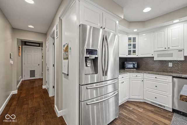 3710 Canada Ct, West Lafayette, IN 47906 - kitchen with appliances with stainless steel finishes, white cabinetry, dark wood-style floors, backsplash, and recessed lighting