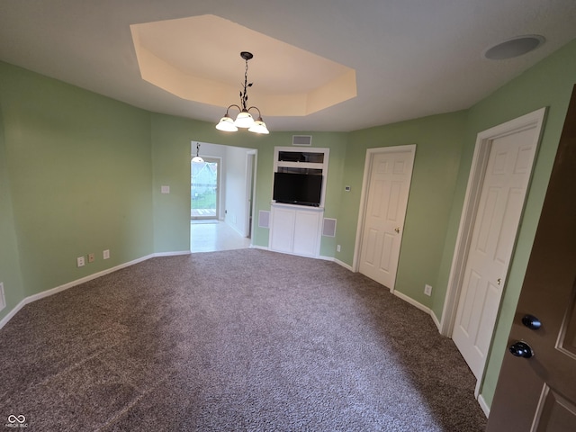 21 Watson Dr, Trafalgar, IN 46181 - unfurnished living room featuring a tray ceiling and carpet