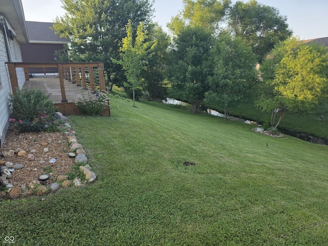 21 Watson Dr, Trafalgar, IN 46181 - view of grassy yard with a deck