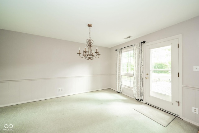 2613 W Queensbury Rd, Muncie, IN 47304 - unfurnished dining area with carpet, a chandelier, and wainscoting