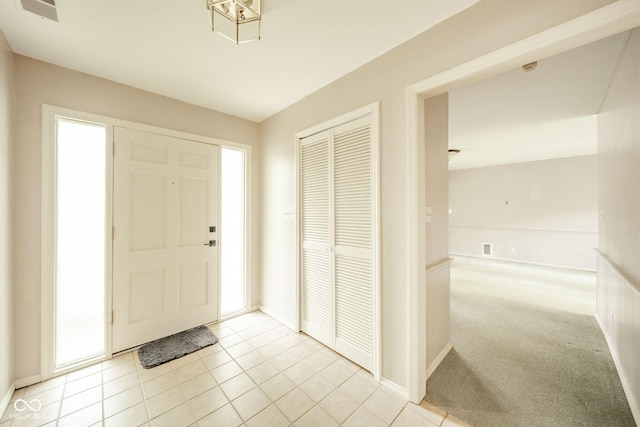 2613 W Queensbury Rd, Muncie, IN 47304 - entryway featuring light tile patterned floors and baseboards
