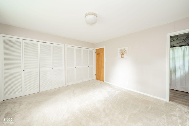 2613 W Queensbury Rd, Muncie, IN 47304 - unfurnished bedroom featuring carpet floors and two closets