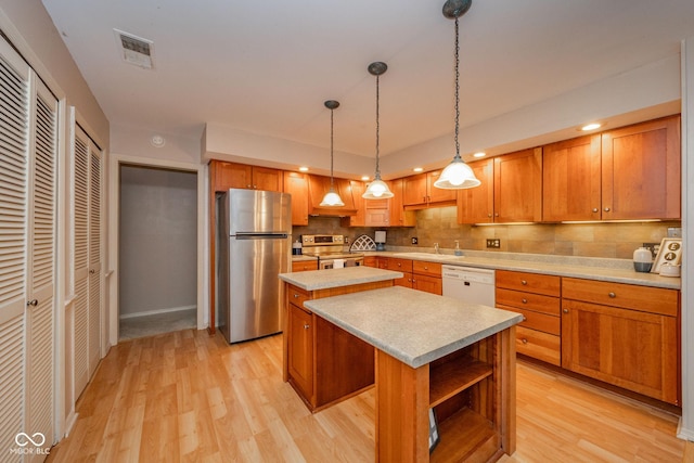 2613 W Queensbury Rd, Muncie, IN 47304 - kitchen with stainless steel appliances, a center island, light wood-style floors, light countertops, and recessed lighting