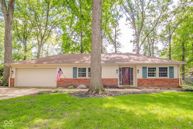 2613 W Queensbury Rd, Muncie, IN 47304 - ranch-style home featuring brick siding, an attached garage, a front lawn, and driveway
