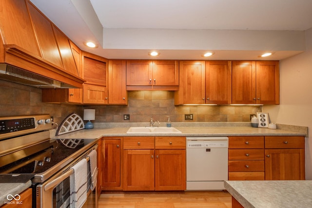 2613 W Queensbury Rd, Muncie, IN 47304 - kitchen with double oven range, dishwasher, light wood-type flooring, brown cabinetry, and recessed lighting
