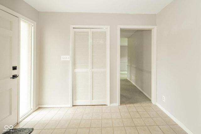 2613 W Queensbury Rd, Muncie, IN 47304 - unfurnished bedroom featuring a closet and light tile patterned flooring