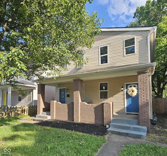 2527 E 10th St, Indianapolis, IN 46201 - view of front of home featuring a porch and brick siding
