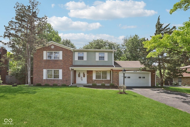 6838 Johnson Rd, Indianapolis, IN 46220 - view of front facade featuring asphalt driveway, a garage, brick siding, and a front yard