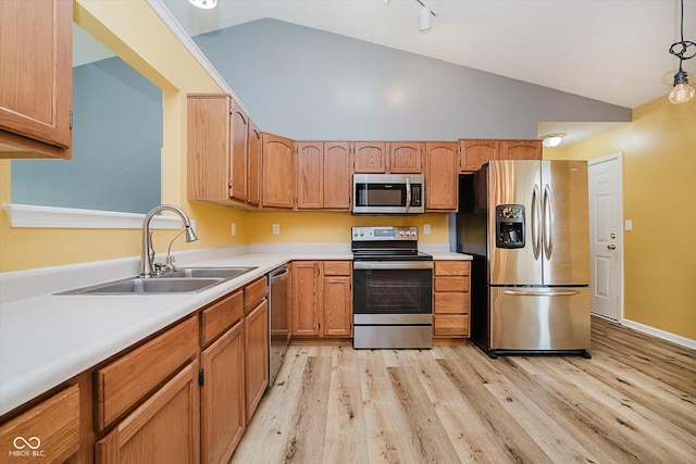 16629 Greensboro Dr, Westfield, IN 46074 - kitchen with stainless steel appliances, lofted ceiling, light wood-style floors, light countertops, and rail lighting
