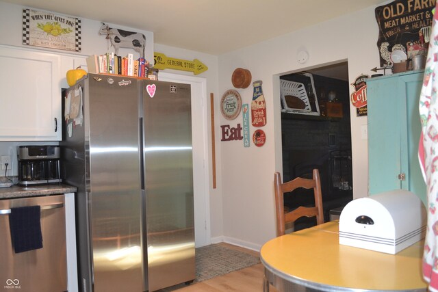 704 S Rockfield Rd, Veedersburg, IN 47987 - kitchen featuring appliances with stainless steel finishes, light wood-style floors, and white cabinetry