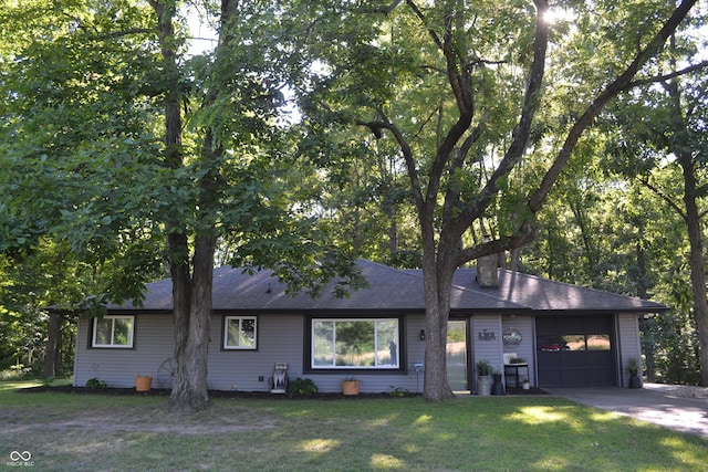 704 S Rockfield Rd, Veedersburg, IN 47987 - view of front facade with an attached garage, a front lawn, driveway, and roof with shingles