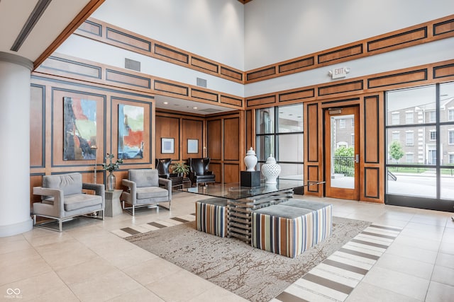 225 N New Jersey St Unit 52, Indianapolis, IN 46204 - living area featuring a decorative wall, light tile patterned floors, and a high ceiling