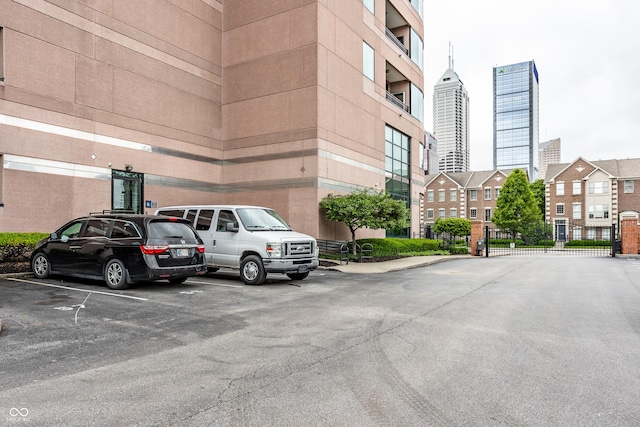 225 N New Jersey St Unit 52, Indianapolis, IN 46204 - view of building exterior with uncovered parking and a city view