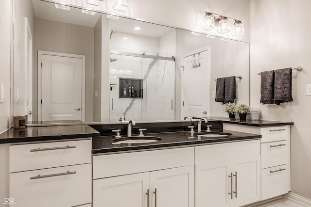 225 N New Jersey St Unit 52, Indianapolis, IN 46204 - bathroom featuring a marble finish shower and double vanity