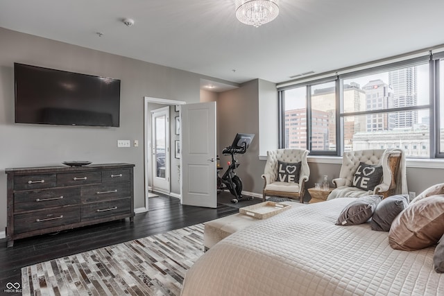 225 N New Jersey St Unit 52, Indianapolis, IN 46204 - bedroom with dark wood-style flooring and a chandelier